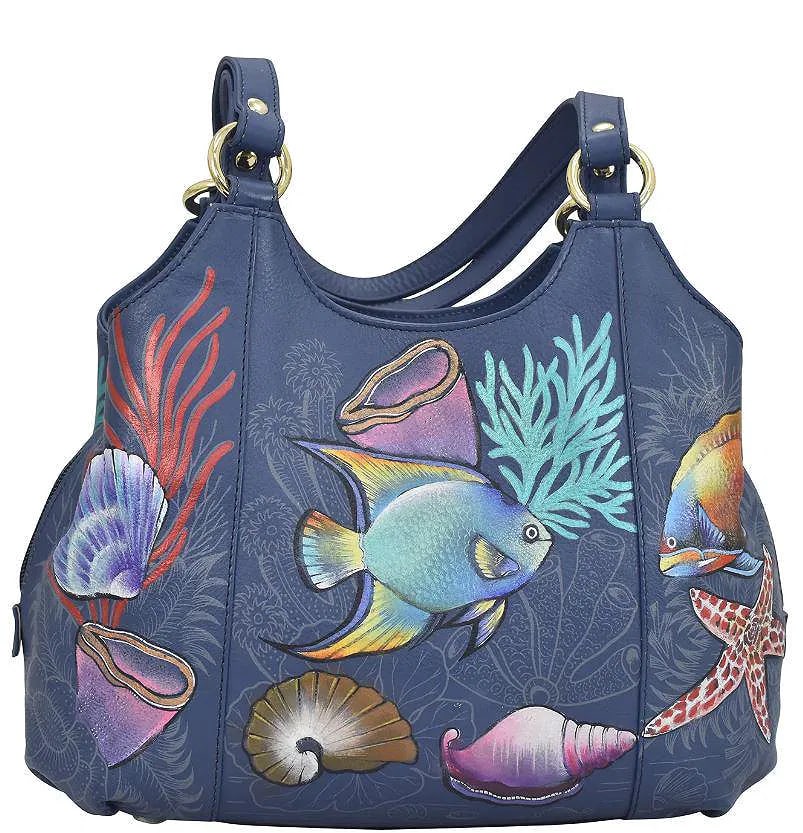 New! Hand-Painted Anuschka Satchel Handbag. "Mystical Reef" . Genuine Blue Leather. Includes: I am new to the Anuschka Bags. The quality is excellent. The hardware still has the protective wrap. Tags are attached. Includes Dust Bag. 12" x 9" x 4".