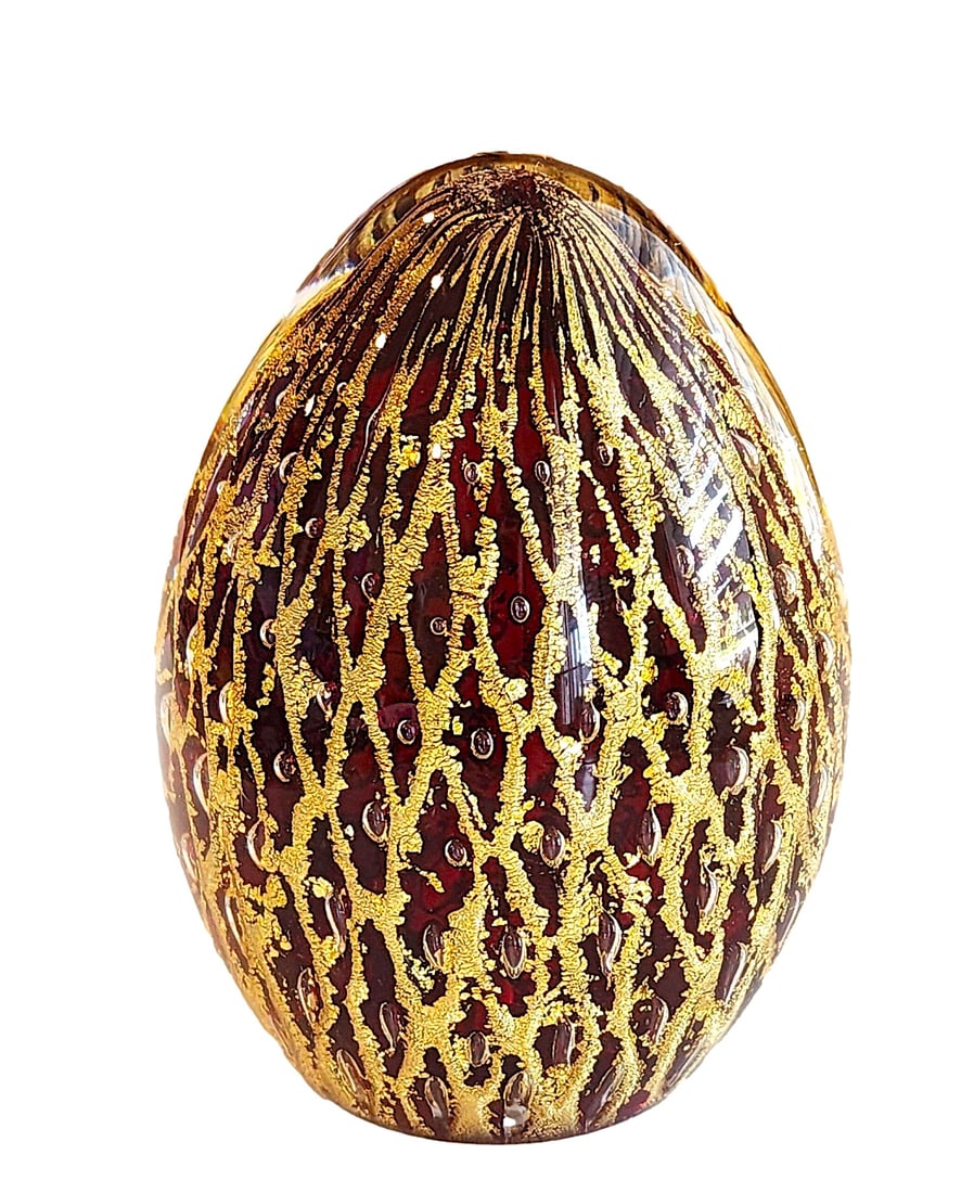 Red with Gold Glitter Waterfall Glass Paperweight. Egg - shaped. Small Bubbles Throughout. 3 1/2": No Mark. Flashy with the gold glitter.