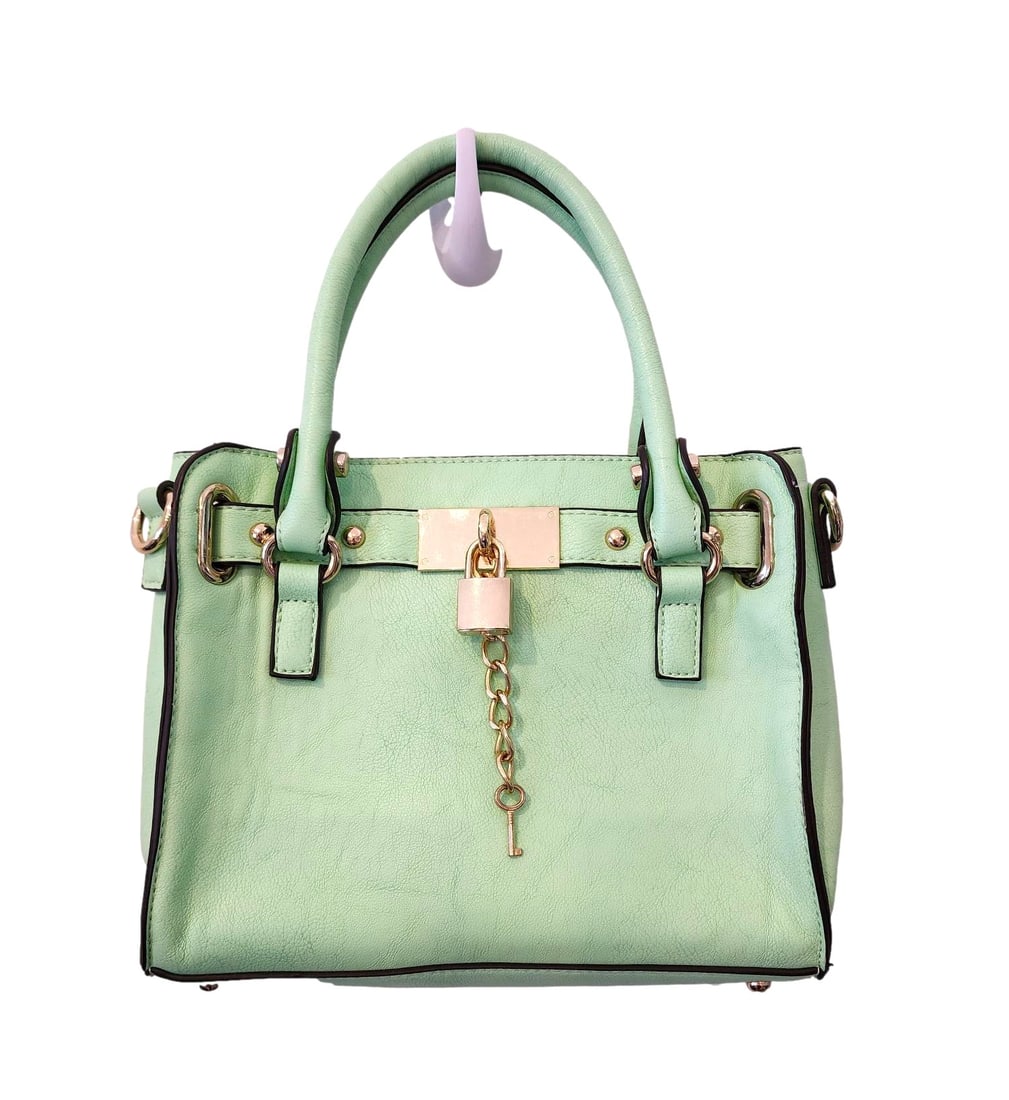 Charming Charlie Mint Green Handbag w/ Crossbody Strap.: This handbag is in new condition. The interior zipper still has the plastic protective cover. The interior has an attractive Black and White Striped Material. Included is a white crossbody strap. Meas