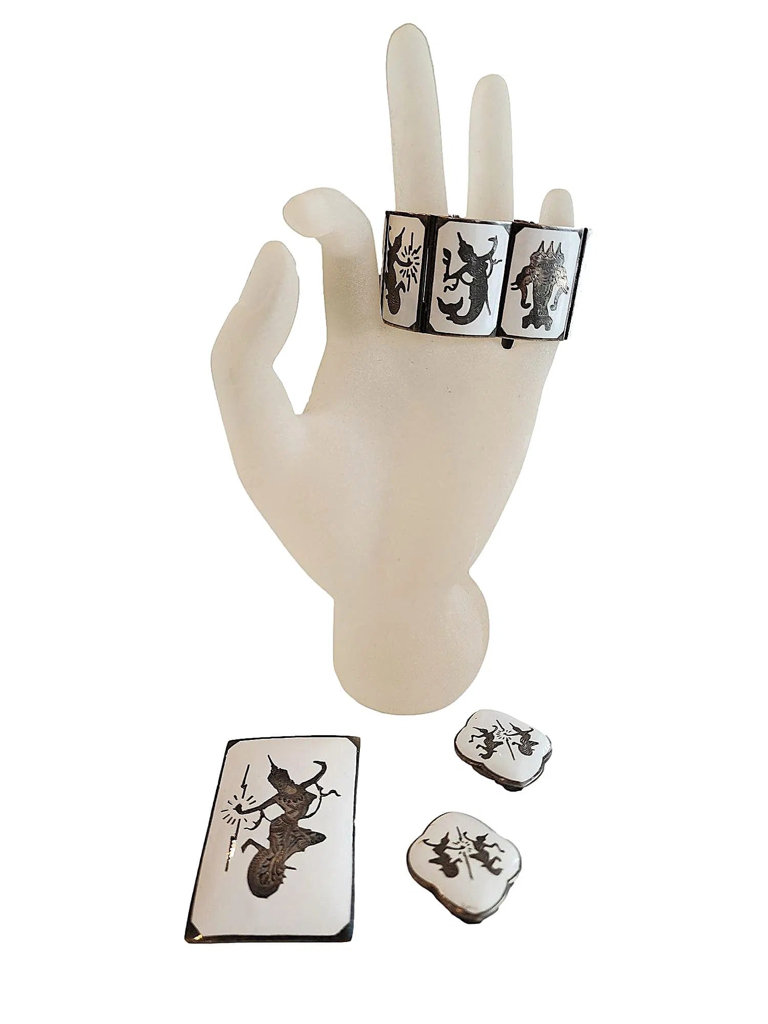Vintage Sterling Silver Krishna Jewelry Set - Siam Silver. Amfarco. Bracelet, Clip Earrings, and: A three Piece set featuring Thai figures. Bracelet, earrings, and brooch. White with silver mythic figures set in and on Sterling Silver from Siam. Bracelet measures - 6 1/2". Nice collection. Earring