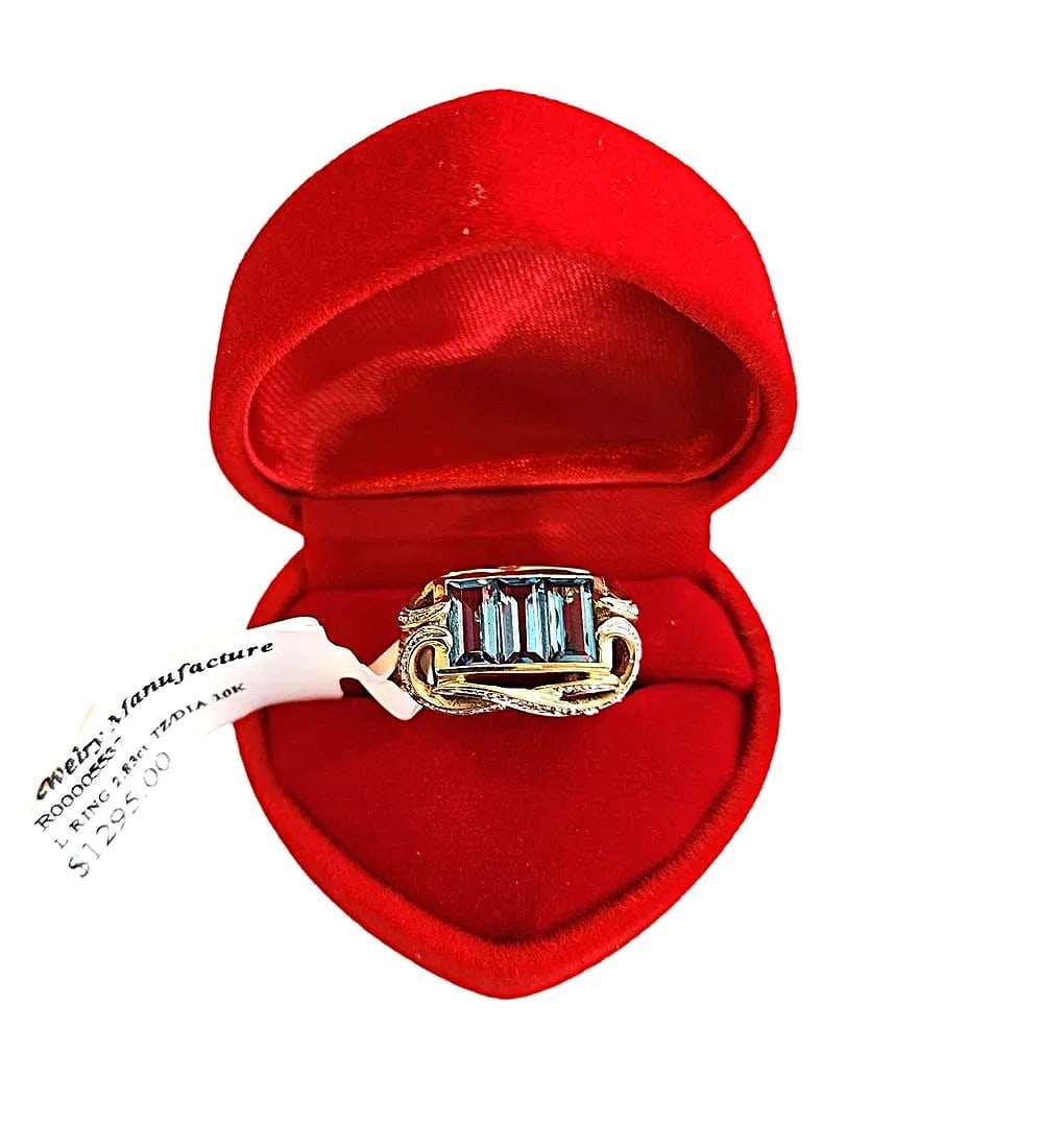 10K Yellow Gold - 2.8ct Blue Topaz with Diamond Chips. 7 - 7 1/4 size.: New with tags - This ring is very nice and features Blue Topaz stones with Diamond Chips in Swirl Design. The original tag is still attached listing this ring at $1295.00 Retail.