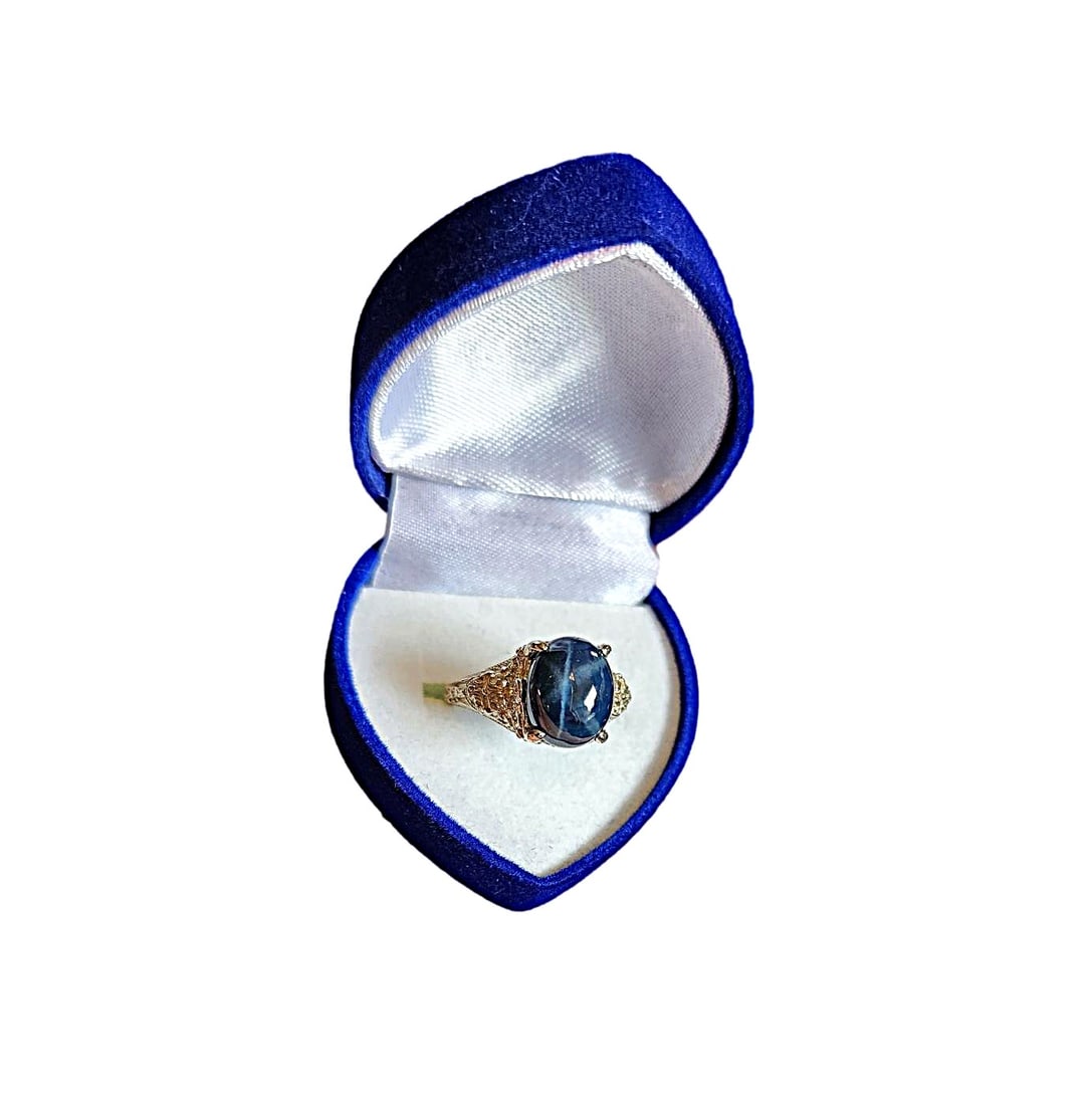 Beautiful Star Sapphire Ring set in 14K White Gold Filagree setting. Size 8 1/2: This vintage ring is part of our in house collection. We purchased it many, many years ago. The sapphire is very nice, the rays are strong in the stone. This ring has been sized in the past. The band