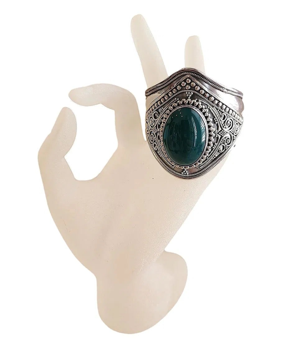 New Large Cuff Sterling Silver Bracelet with an Oval Cabochon Green Stone.: A large Sterling Silver Cuff Bracelet featuring a large green oval stone center. Metal work is intricate. Stamped 925. The metal is flexible for adjustable fit.