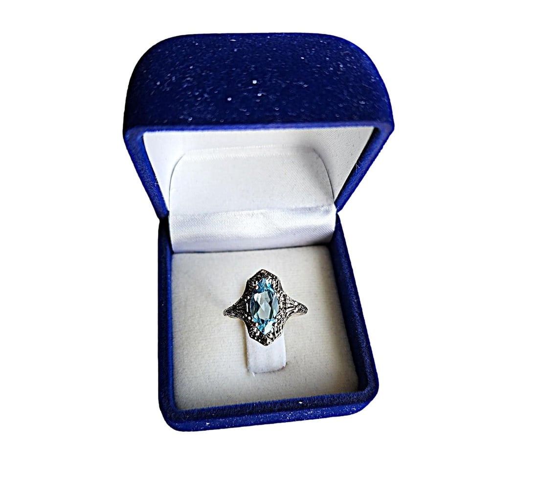 Vintage Blue Topaz Marquis Cut Stone in a Filagree Sterling Silver Setting: This is another one from our house collection of vintage jewelry. Very pretty filagree setting. The topaz is nicely colored and a quality stone. I do not have stone size/kt weight. Size 7 1/4.