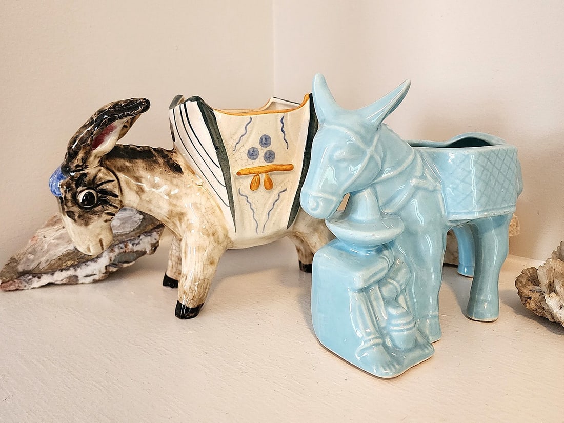 2 Donkey Planters - Previously owned.: One all blue planter and on brownish planter. Both measure approx. 8" by 6". The brown donkey has generalized crackle to the finish. No maker's mark.