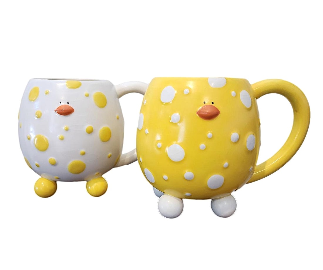 Duck Mugs by Gantz: Adorable pair of character mugs featuring ducks in yellow and white. Made by Gantz. Microwave and Dishwasher safe. Measures: 5" x 6"