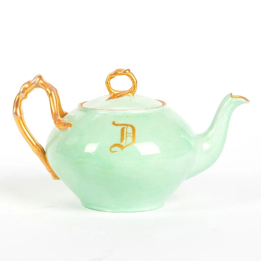 Jean Pouyat Limoges French Ceramic Teapot - Green with Gilt: From a Private Collection. Green with gilt detail, D monogram. Stamped JP L to bottom. Some wear to gilt detail on handle. 20th Century. Dimensions: 8.5"L x 5.5"W x 4.75"H Country of Origin - France