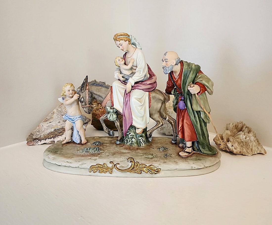 Vintage Capodimonte Porcelain Figurine featuring Mary & Baby Jesus & Joseph: 1954-2000. Marked Pucci. Italian Origin. Features Joseph and Mary with the Baby Jesus. Mary is on a Donkey being led by an Angel. Being fragile, this piece will require special packaging. If you need 