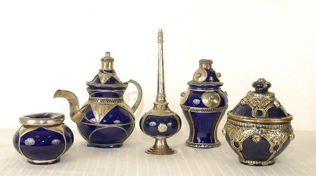 5 Piece Moroccan Teapot Set with Matching Canisters: Hand crafted - decorative 5 piece set in a dark blue with silver plate. Turquoise stones adorn the canisters. Due to the number of pieces, extra care will be needed for shipping. If you require a