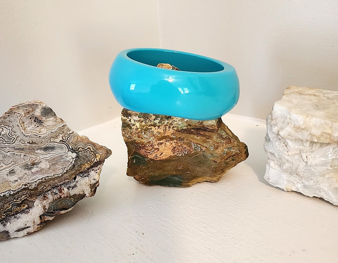 Vintage Turquoise Blue wide Bangle Bracelet - unmarked: The bracelet is a solid Turquoise Blue with a glossy finish. Irregular in shape and unmarked. Interior diameter 2 1/2". Very nice accent piece.