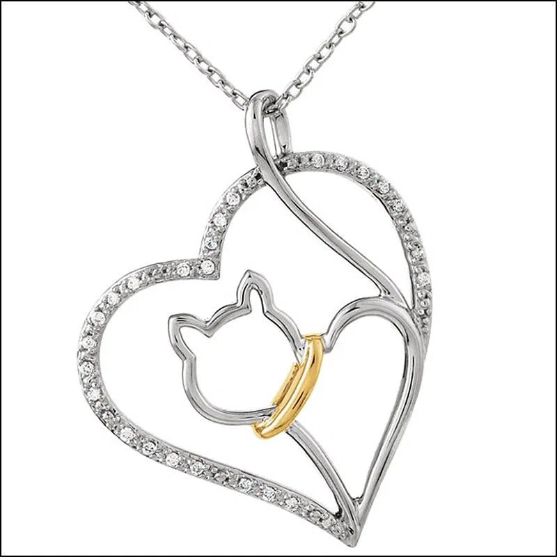 Tender Voices Cat Heart Necklace - Diamond Chips: Sterling Silver with 10K Yellow Gold and Genuine Diamond Chips. Features a cat silhouette with a 10kt gold collar and diamond chips edge the heart. 1/10ctw. 18" chain. Gram Weight - 2.69.