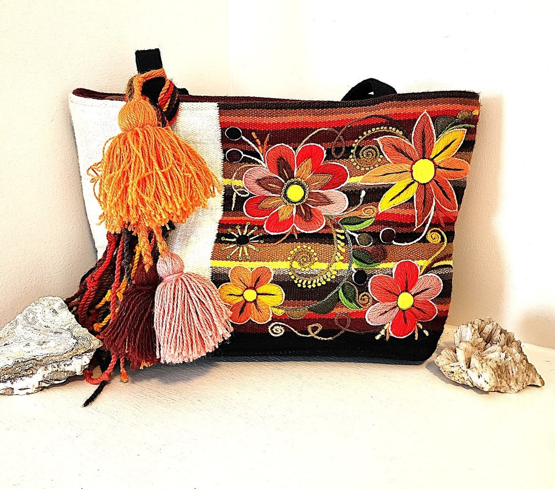 Boho Shoulder Bag Featuring Floral Embroidery and Canvas: No Maker known, but this bag is gorgeous. The front embroidery panel features raised flowers. The back panel is southwestern. The base is canvas and the straps are canvas. Included are decorative Yarn