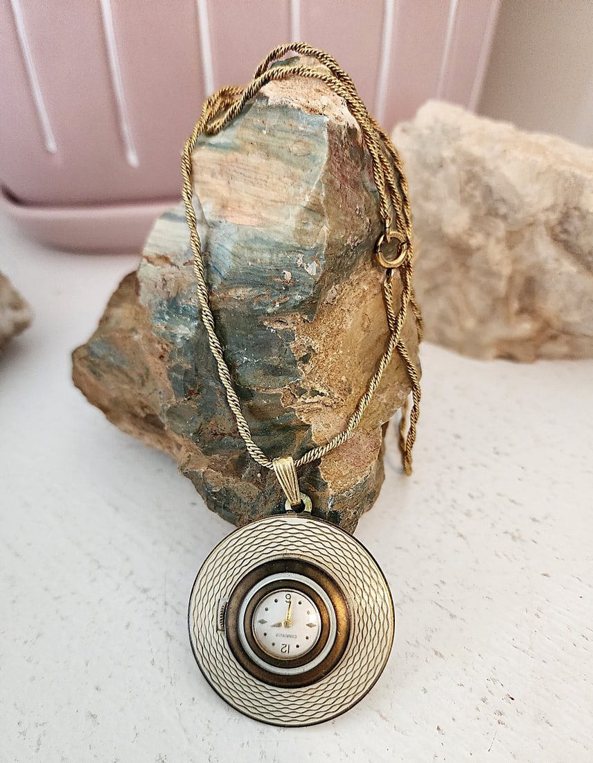 Vintage Necklace Watch by Caravelle - 24" gold metal chain. - Running: Winding mechanism. The case has a clear back so you can see the operation. 7 jewels. Running condition. This is a really nice piece.Caravelle necklace watches—often referred to as pendant watches—