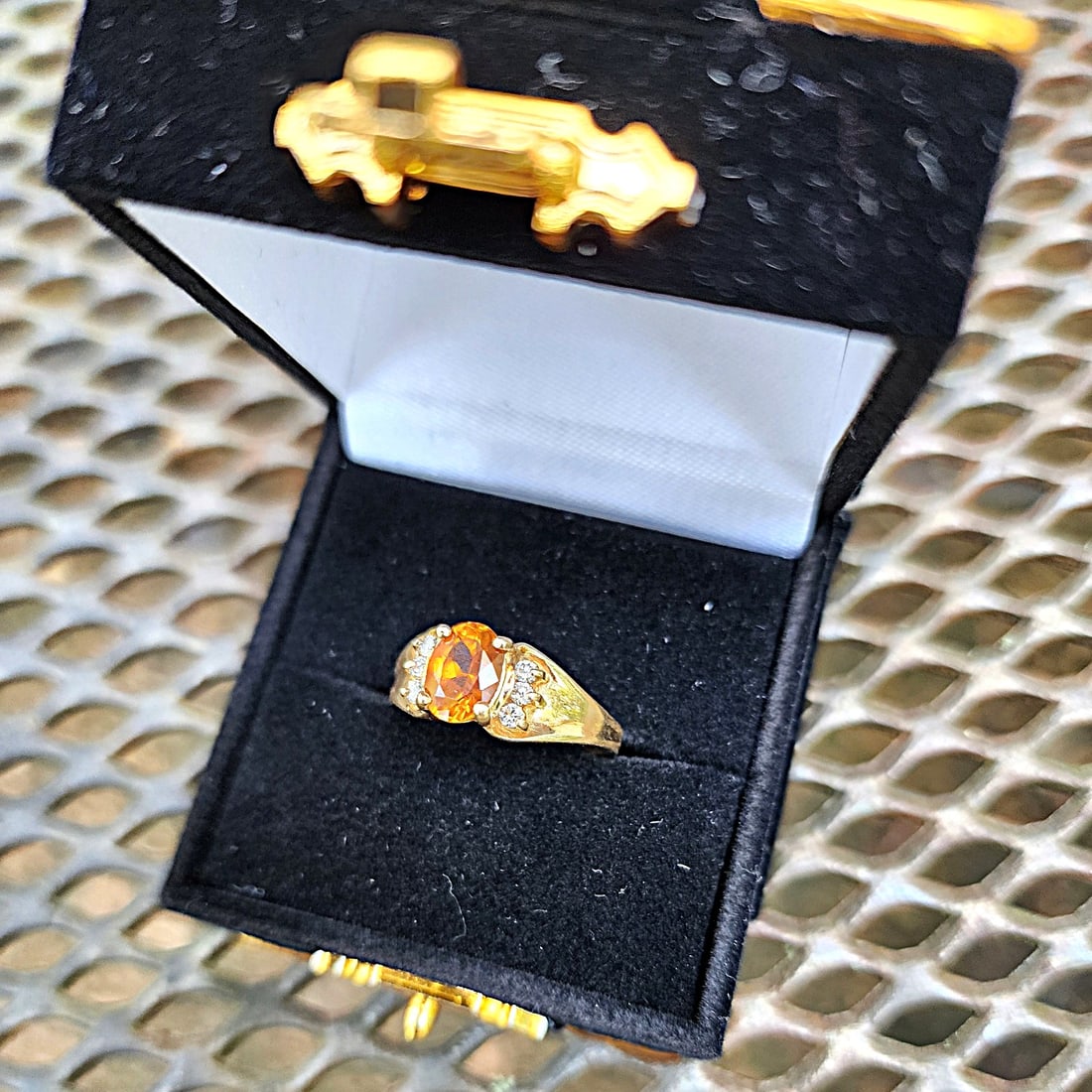 Orange Sapphire and Diamond Ring set in 14K Yellow Gold Ring - Size - 7: I purchased this ring in 2000. it was my first purchase into Orange Sapphires. This stone still intrigues me with its clarity, color, and fire. On the sides of the main stone are 6 diamonds - 3 on eac