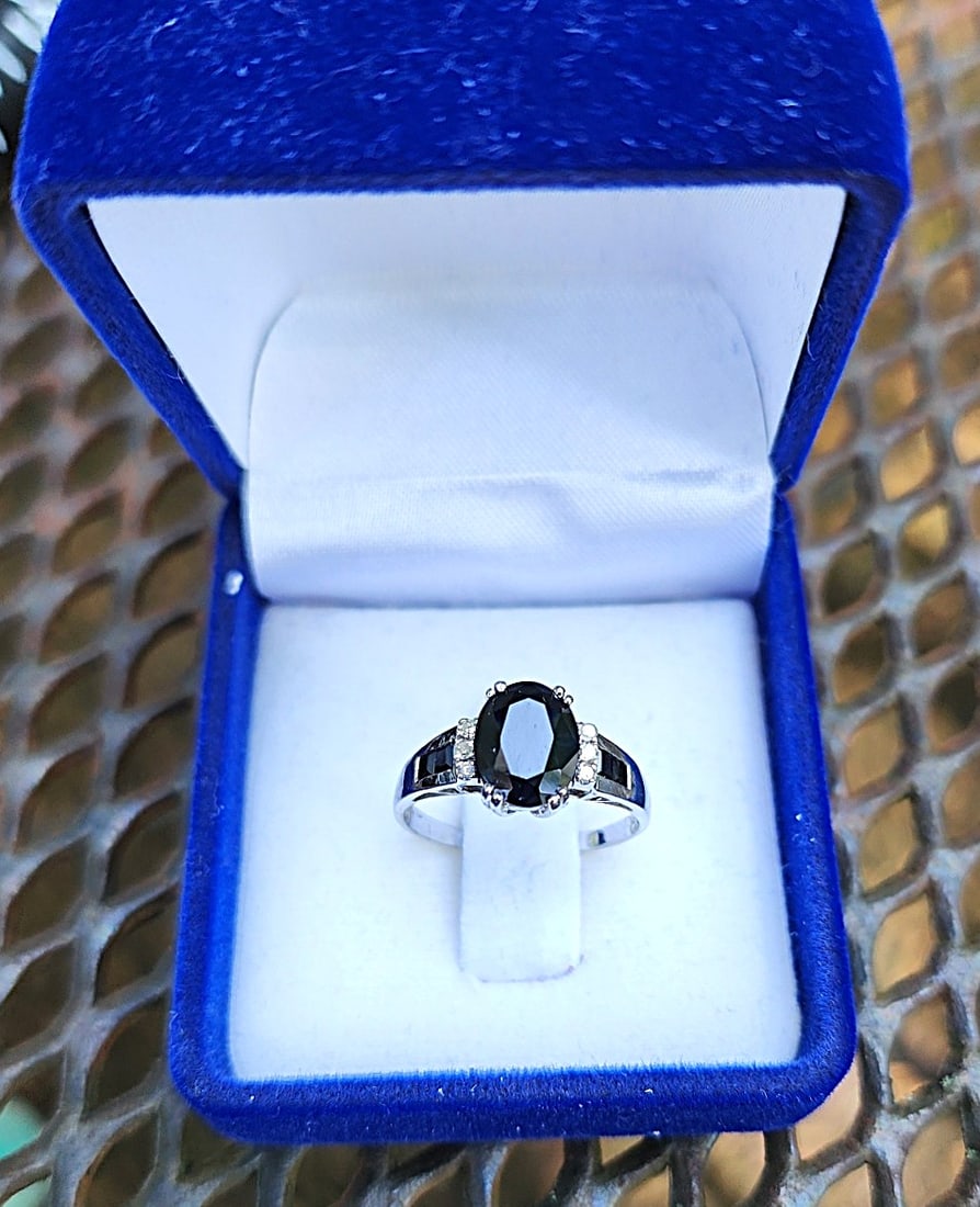 Black Sapphire with Diamonds Ring set in 9K White Gold - Size 7 - 7 1/4: This Black Sapphire Ring is very nice. Large - approx. - 2 ct. to 2 1/4 ct. Black Sapphire center stone, on the sides of the center stone are 6 diamond chips, and set into the side bands are 4 square 