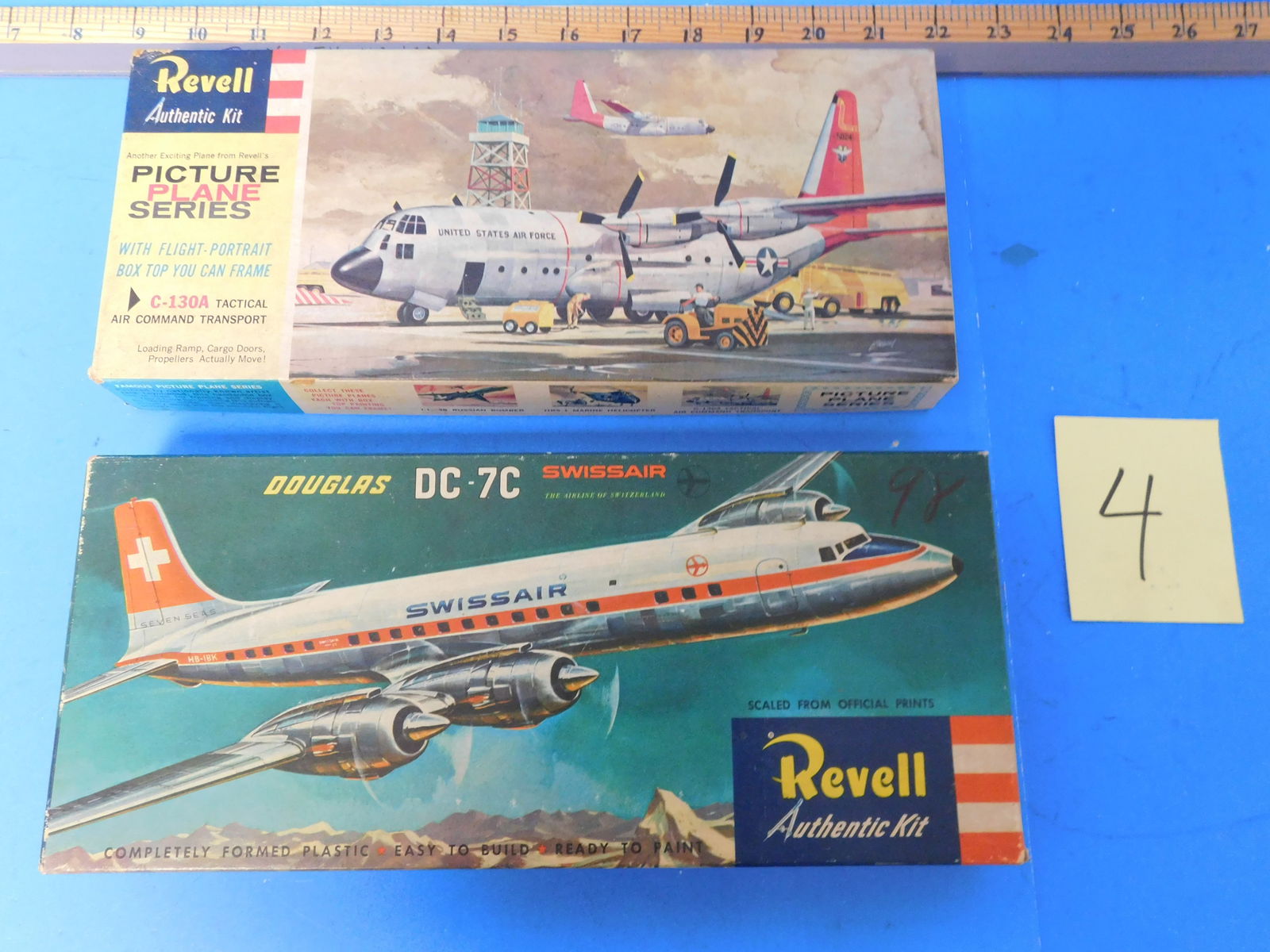Revell Vintage Plane kits C-130a and DC-7C.: Vintage Kits are open on has been started. Parts are loose in box. Boxes show shelf wer and rubs and fading. See pictures for all part info.