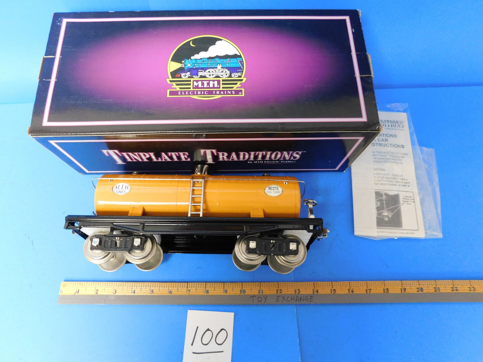 MTH Tiniplate Traditions 10-1050 Orange Tank Car with Nickel. From Warehouse Standard gauge: MTH Tinplate Traditions. 10-1050 #215 Tank Car. Standard Gauge. From MTH warehouse. Comes with Retail box. Showing storage and shelf wear. Color is Orange with Nickel Trim.
