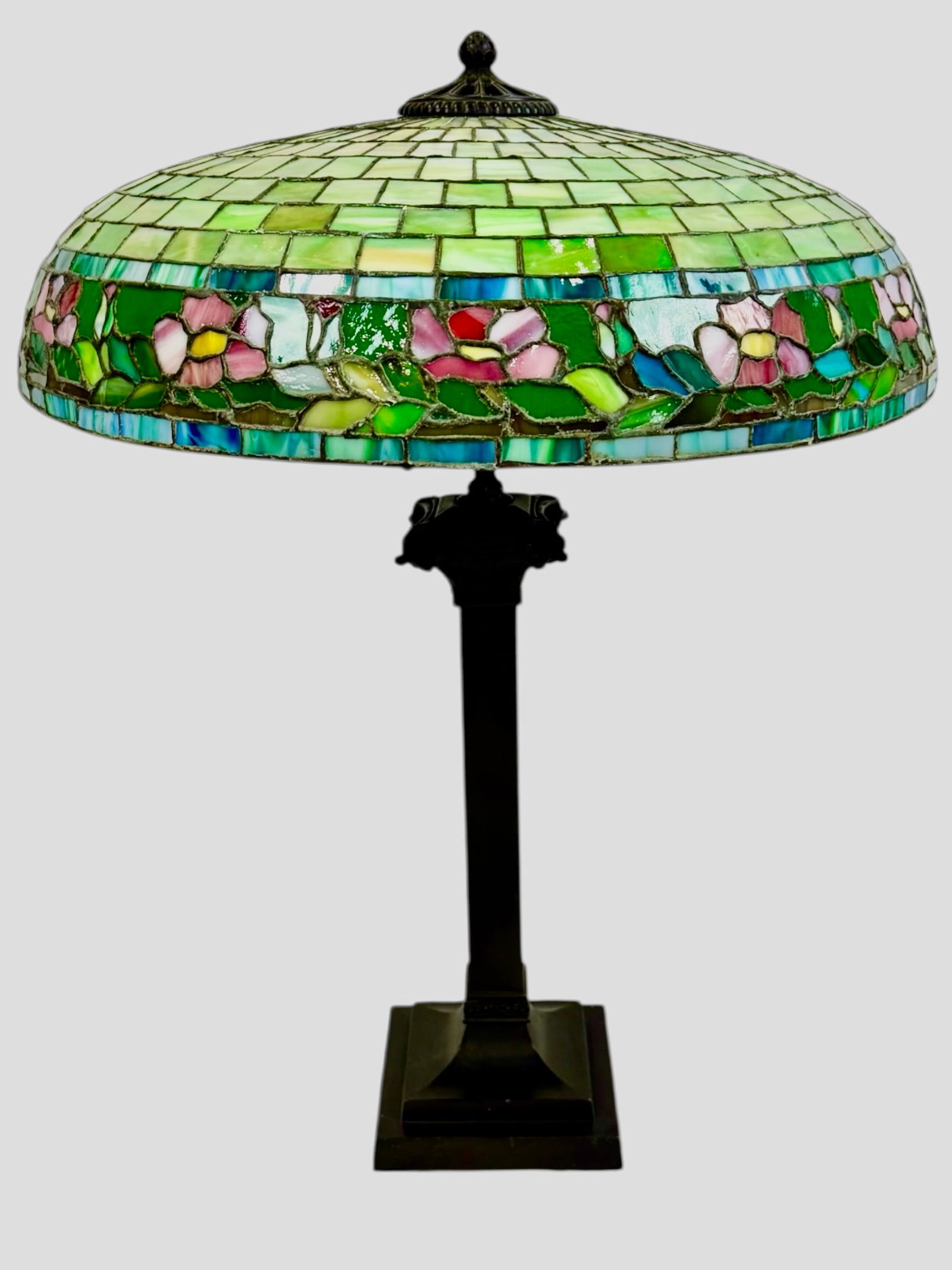 C. 1920's Wilkinson Leaded glass lamp Poppy Floral: Beautiful, and vibrant colored Poppy floral leaded glass shade, with stunning turquoise bands dilineating the top and bottom of the floral and leaf skirt. A variation of this lamp is featured in the W