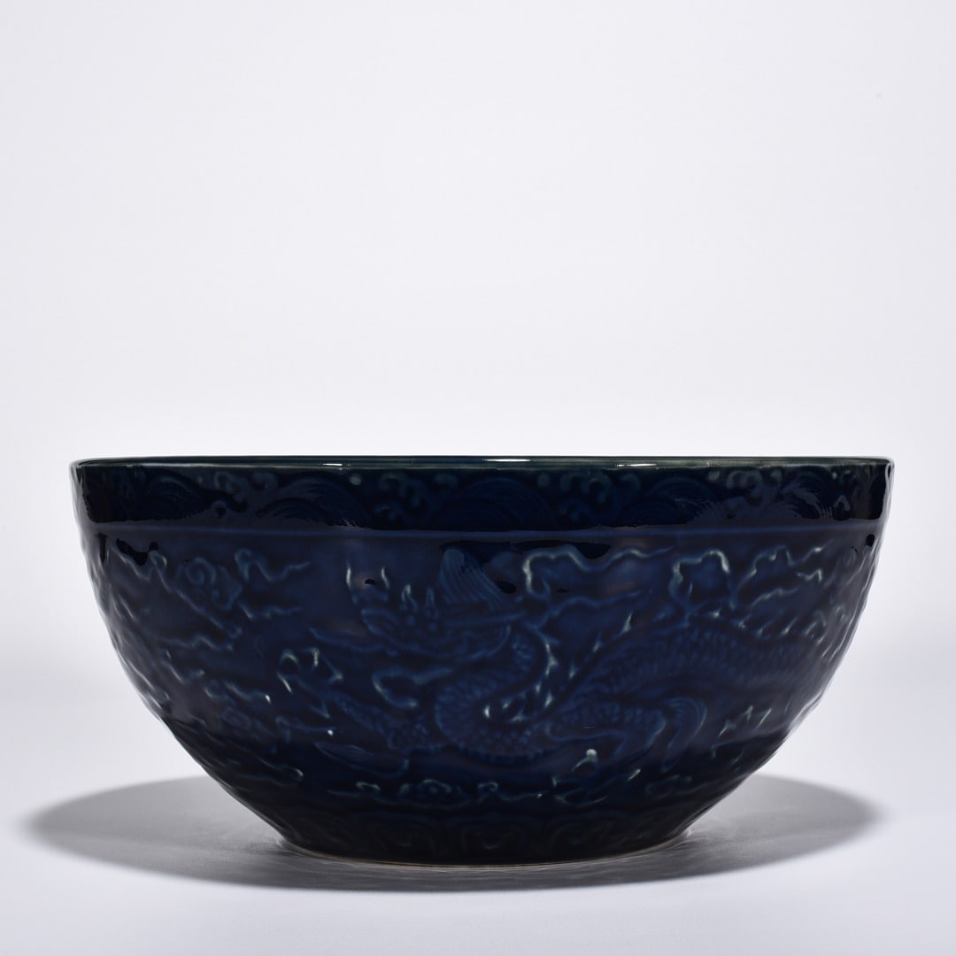 Ming Dynasty Xuande blue-glazed carved cloud and dragon bowl: Size: Width 27.3 cm - Height 12.5 cm Materials: Porcelain Time Period: Ming dynasty Manufactured Date: Xuande Mark & Period Object: Chinese Antique ⛨ Purchase With Confidence ✔ Veri