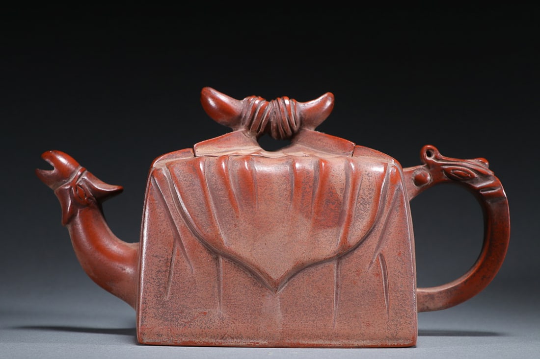 ZISHA 'CLOTH WRAPPER' TEAPOT: Wu Yun Gen mark. Dimension:19.0cm x 10.0cm x 8.5cm Weight: 518.7g Property from a South-Asian private collection. Please contact the specialist department to request further information or additional