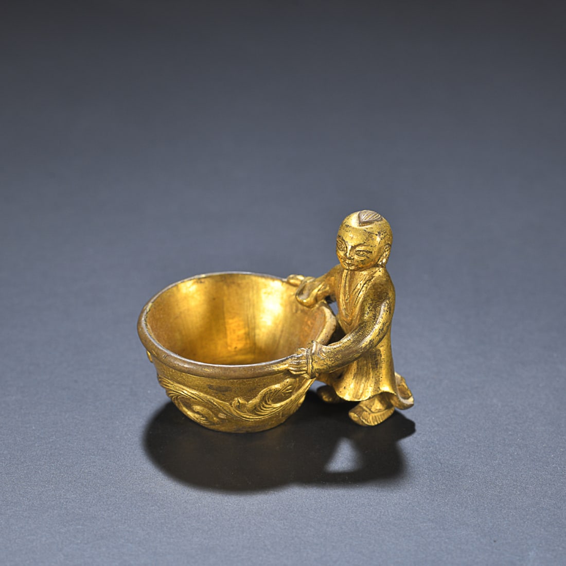 GILT-BRONZE WATER POT WITH A BOY STATUE: Dimension: Height: 4.9cm, Width: 5.9cm Weight: 134g Property from an European private collection. Please contact the specialist department to request further information or additional images that may