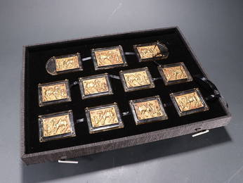 A GROUP OF ELEVEN GILT-SILVER-INLAID CRYSTAL 'FOREIGNER TRAINING CAMEL' BELT PLAQUES