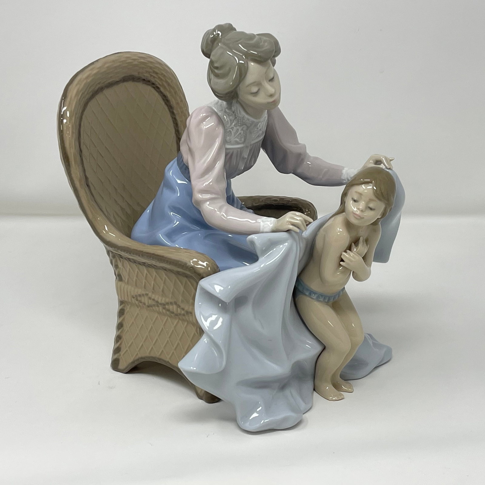 Lladro “Mommy It's Cold” 5715 Porcelain Figurine: Glossy finish; Lladro backstamp. Artist: Joan CoderchIssued: 1990 - 1993 Dimensions: 13.5”W x 11”D x 11”H