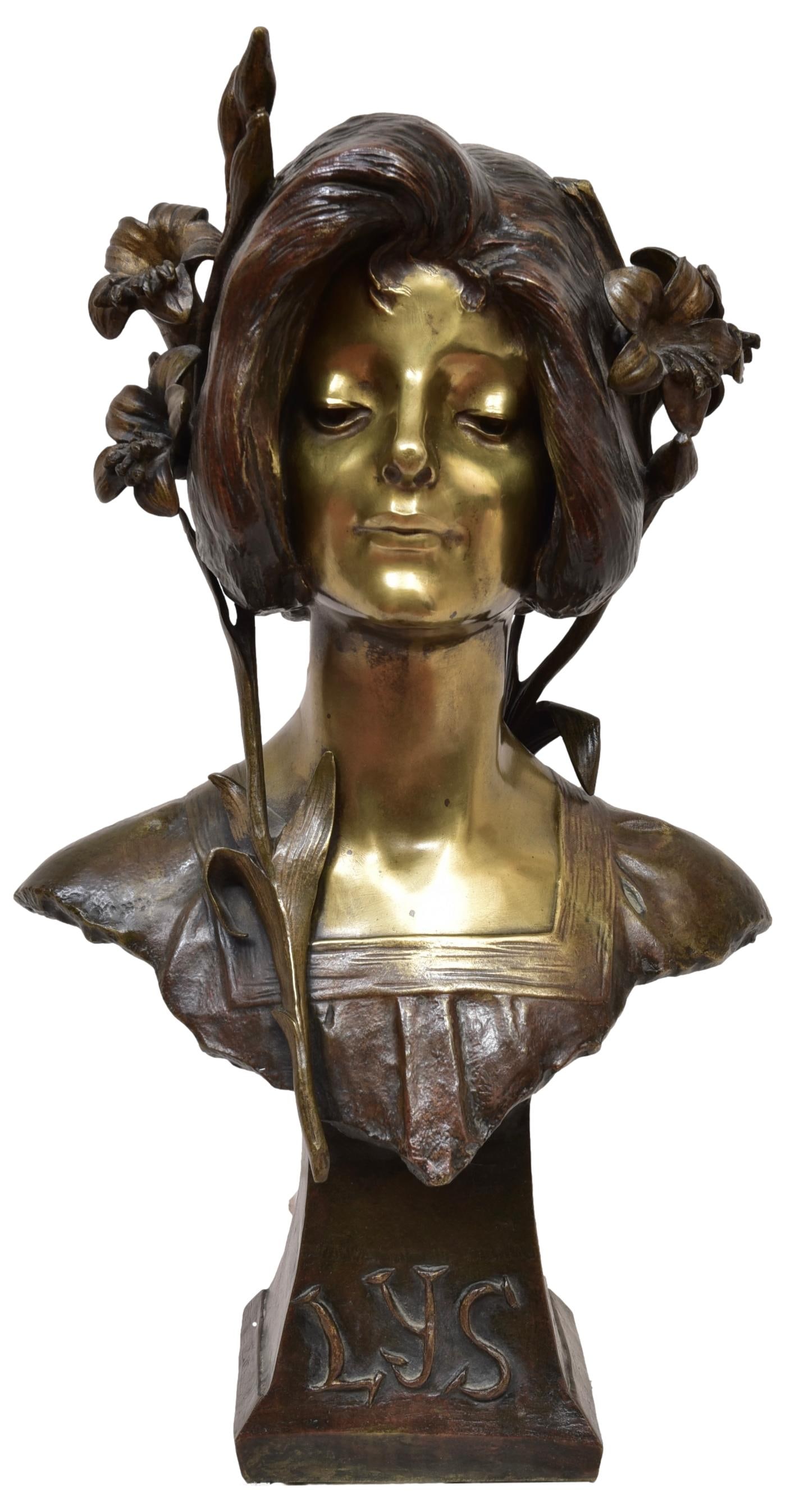 Julien Caussé (French, 1869-1914) Bronze Bust of an Art Nouveau Woman Titled LYS: Bronze bust modeled as a maiden bearing the title "LYS" in relief to the plinth. Signed 'J. Causse' to the plinth. Dimensions: 12 1/2”W x 8 1/2”D x 23”H Town Auction House & Gallery