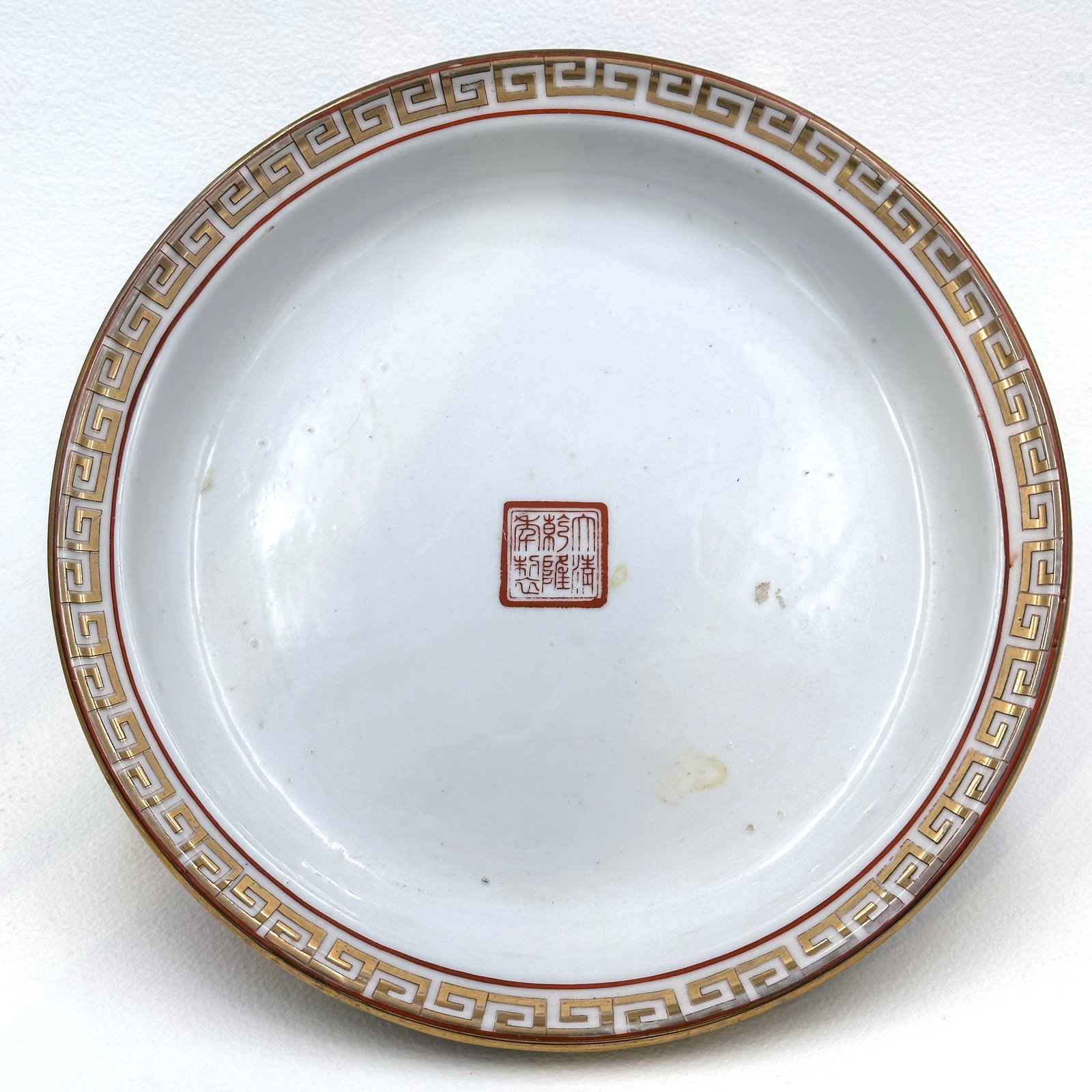 Handpainted porcelain dish with gold luster, Chinese, early 20th century: Handpainted neoclassical motif rim. Stamped with maker's mark center inside. 20th century piece, in excellent condition.