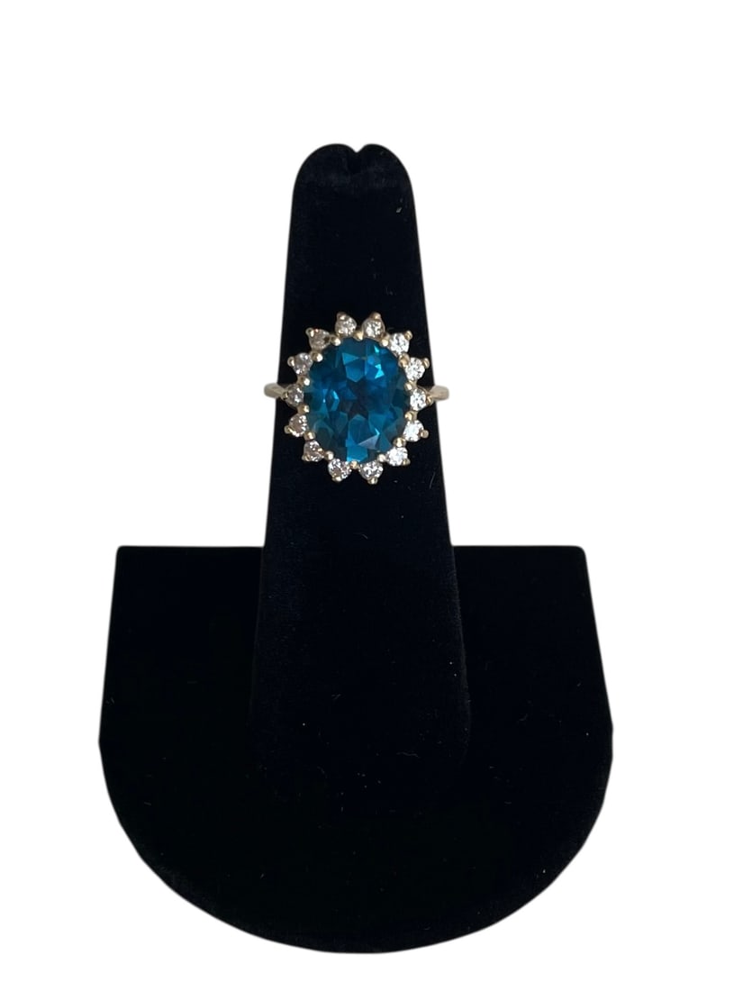 Blue Topaz and Diamond Cocktail Ring, 14K Gold ~ 4.8 grams: Blue Topaz and Diamond Cocktail Ring, 14K Gold ~ 4.8 grams A large center stone surrounded with 14 round diamonds, in yellow gold. Size 5 3/4. Marked 14KP.