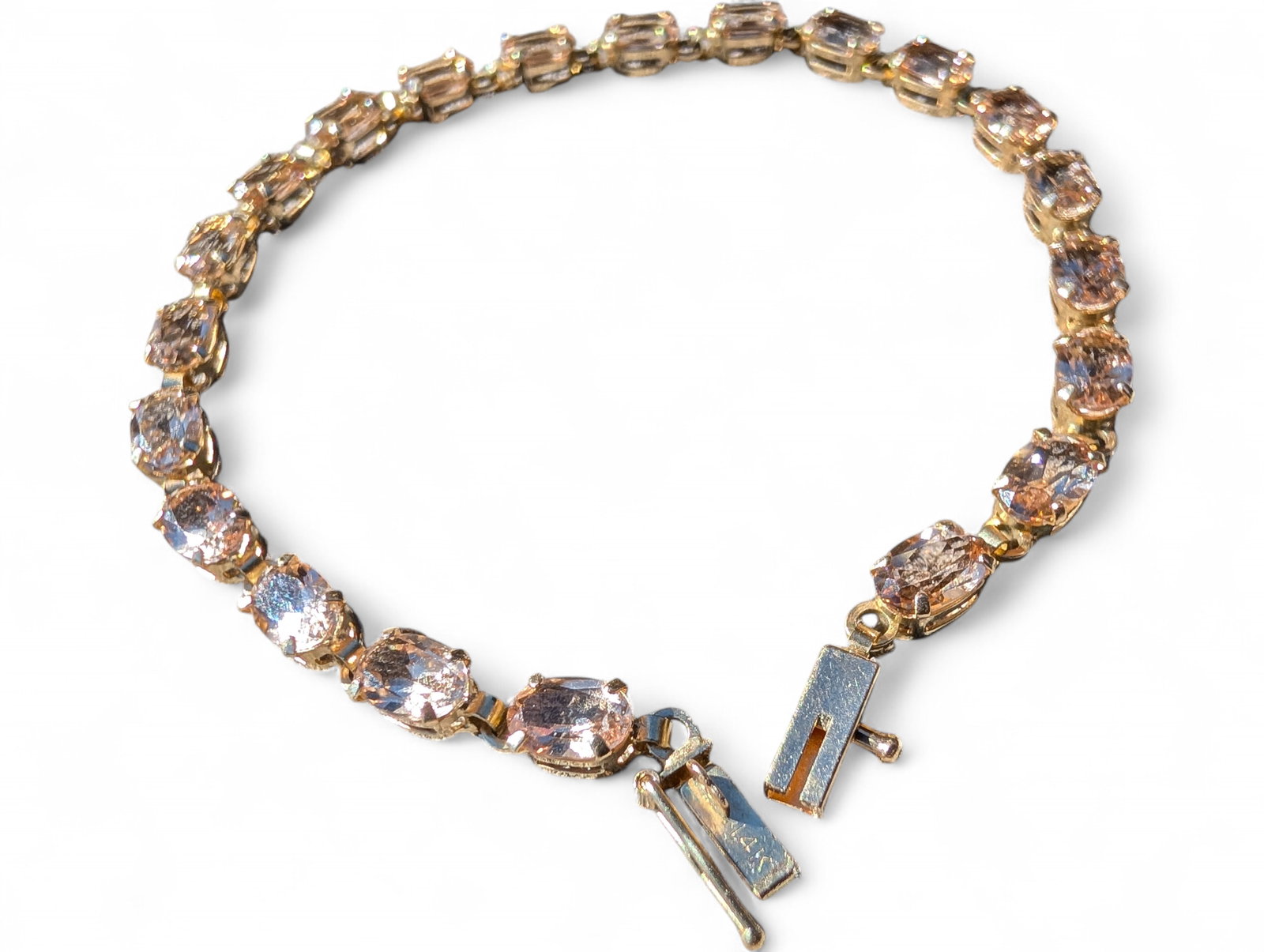 14 Karat Yellow Gold ~ Clear Topaz Tennis Bracelet ~ 5.9 Grams: 14 Karat Yellow Gold ~ Clear Topaz Tennis Bracelet. It gives off an appearance its champagne color when worn because it is clear.