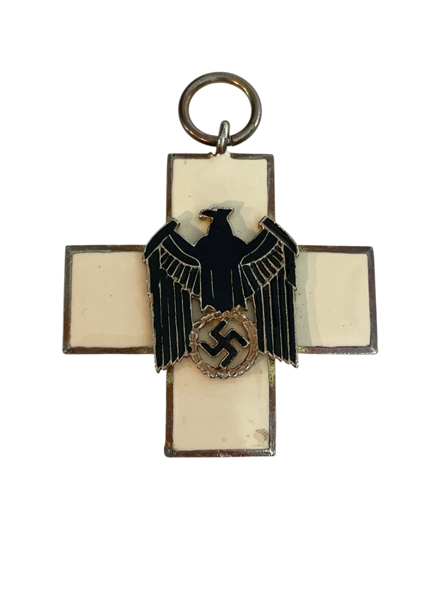 WWII German Social Welfare Medal: WWII German Social Welfare Medal. Enameled metal. The ribbon may or may not go with this piece, but we are including it. Maker's stamp on the back: Deschlersohn. 2 3/8" long including ring.