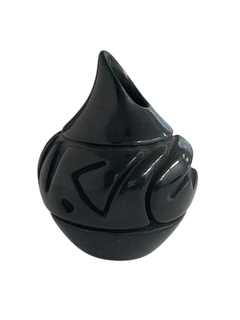 Denise Chavarria Santa Clara Pueblo Blackware Vase: Small carved pottery vase with diagonal rim, signed on the bottom: Denis Chavarria / Santa Clara Pue. 3 3/4" tall.