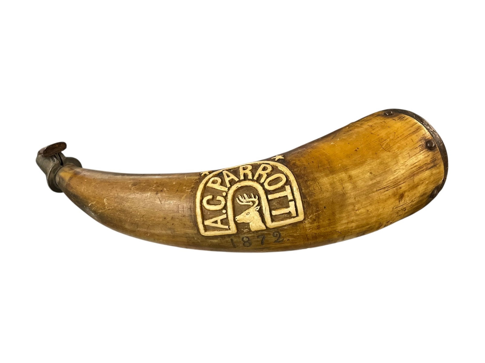 1872 Powder Horn, Carved 'A.C. Parrott': A cow's horn for holding gunpowder, carved with a raised design of a stag deer and the name A.C. Parrott. Below it is the date 1872. This piece may have been deaccessioned from a museum, w