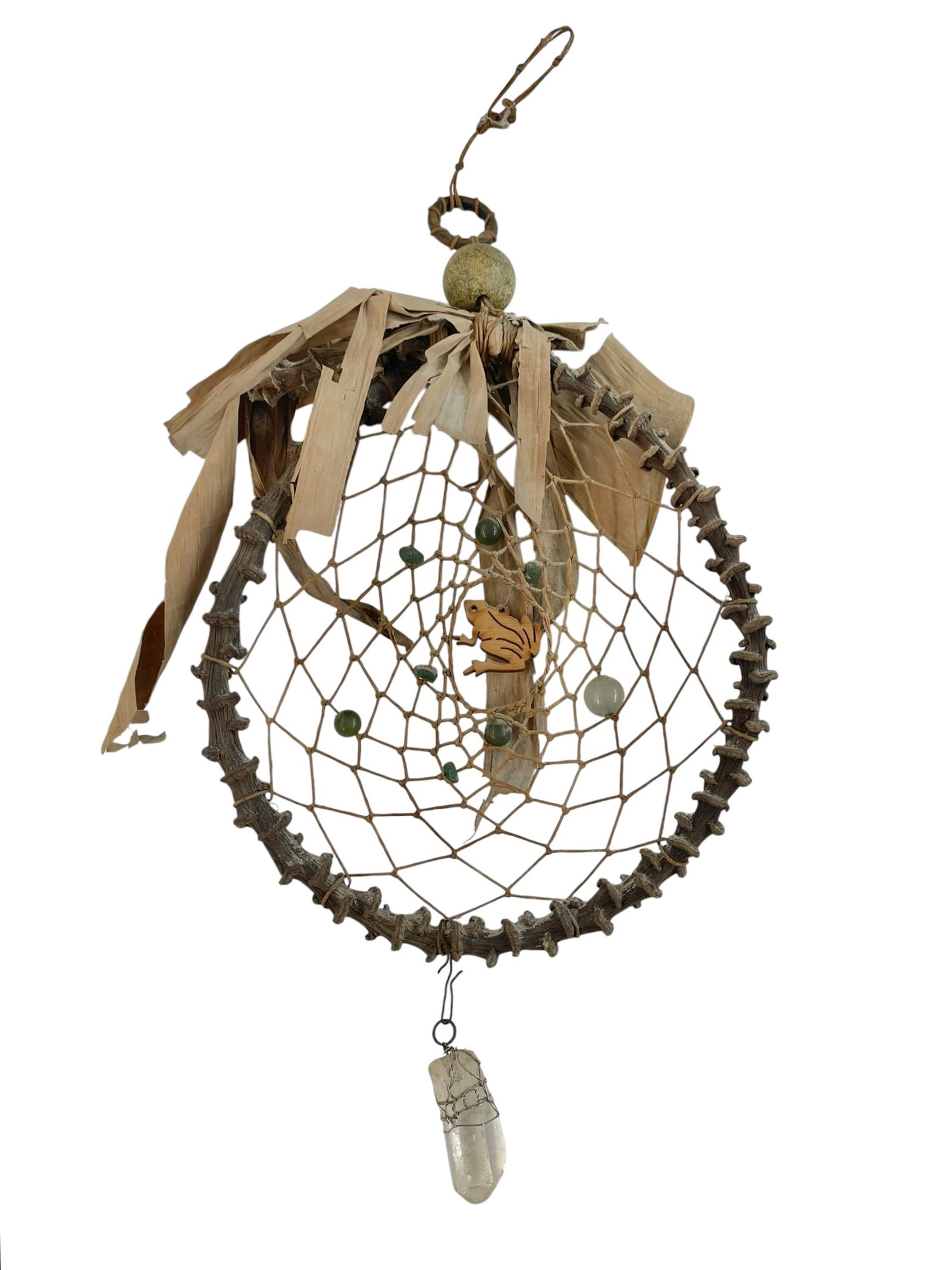Native American Handmade Dream Catcher: Traditional wall hanging piece made from a tree branch, with a wooden frog in the center. Accented with green semi-precious stones and a clear raw quartz at the bottom. About 13" at
