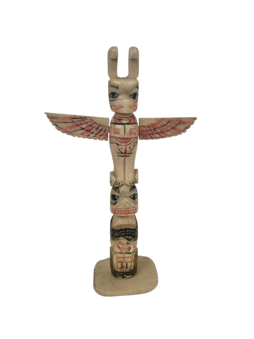 Carved Bone Totem Pole, 4.25': Northwest Coast or Alaskan, Native American. A small totem pole carved from bone, and painted/colored. The base detaches easily and the wings will detach too.