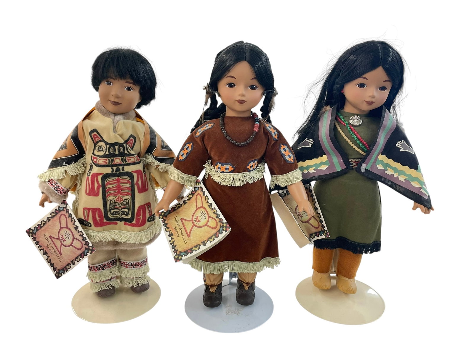 3 Sandy 13' Porcelain Dolls, Native American Series: Names are: Standing Moose, Happy Moon, Very Sweet Woman. With original tags by Sandy Dolls, 13" tall. Stands included.