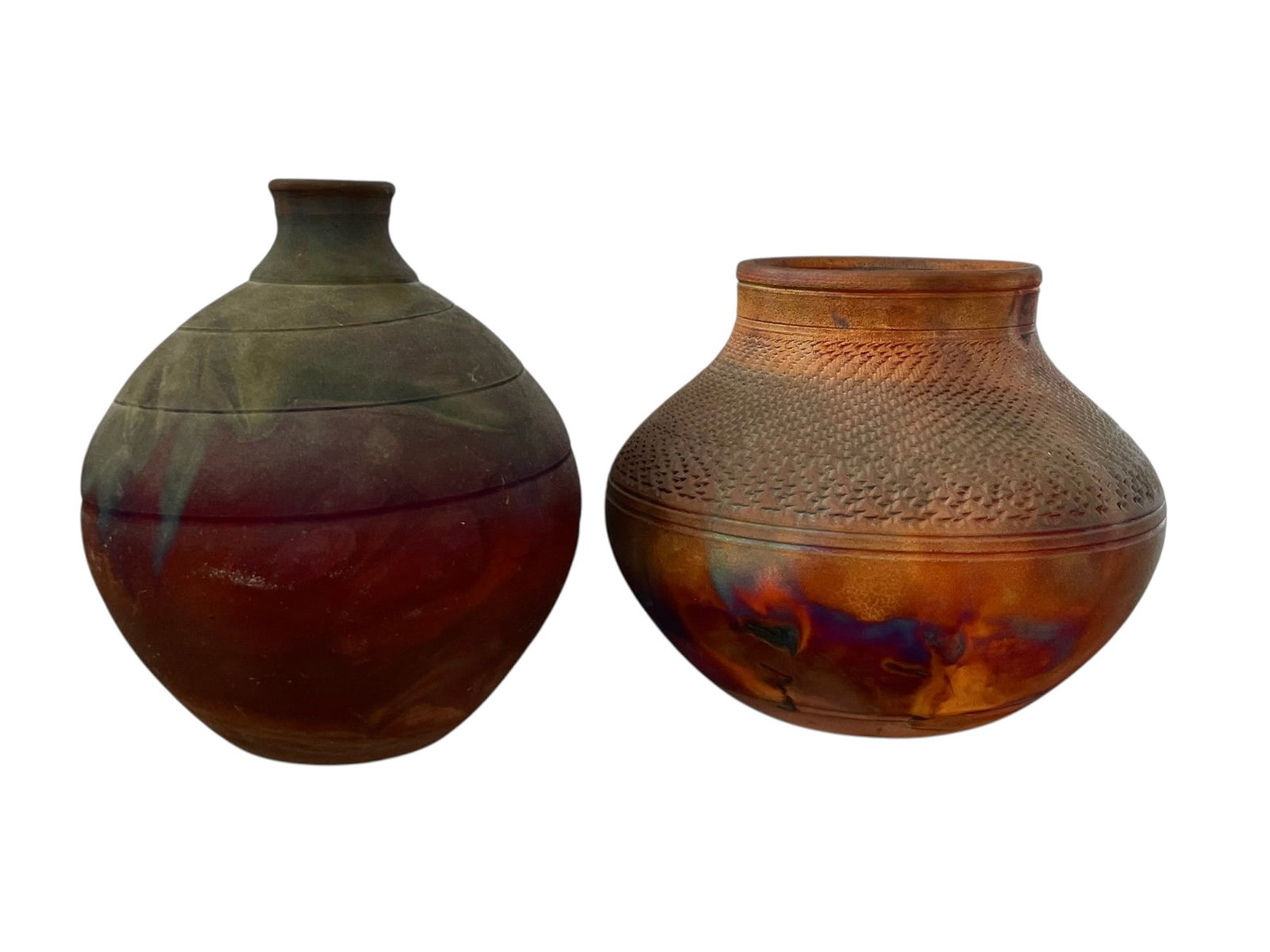 2 Raku Pottery Vessels by Joe Frank McKee: Each is signed: McKee. One is 7" tall with minimal spiral design. The other is 6" tall with an incised design. It has a crack in the base on the signature; please see photo.