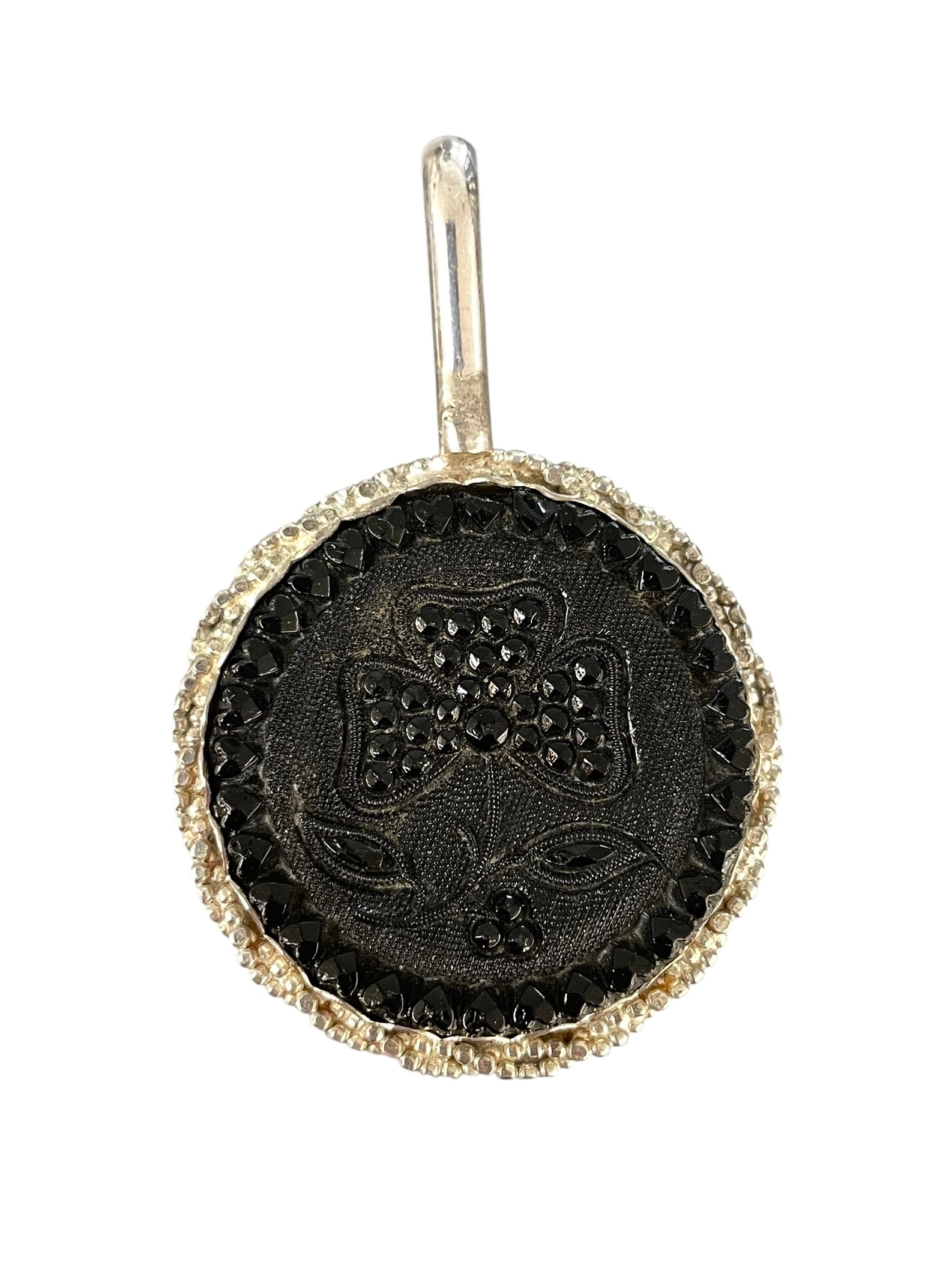 Antique Gutta Percha Button Pendant, Sterling Silver: An antique button with flower design, set in a handcrafted silver bezel pendant setting. Marked: Sterling. 1 3/8" diameter and 2 1/8" total length with bail.
