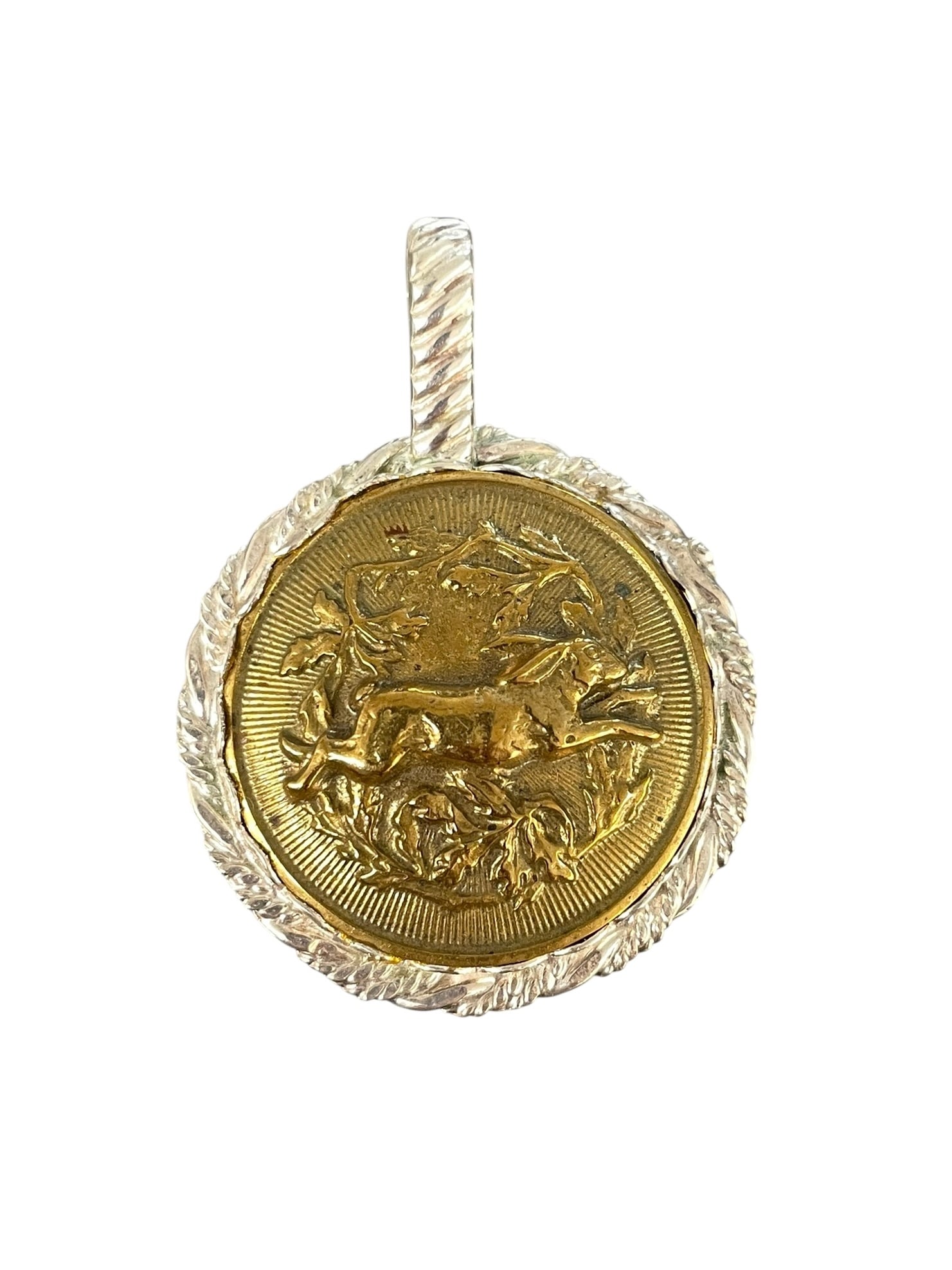 Antique Running Rabbit Button Pendant, Sterling Silver: An antique button depicting a wild hare running through leaves. It's set in a handcrafted silver bezel pendant setting. Marked: Sterling. 1 1/4" diameter and 1 3/4" total length 