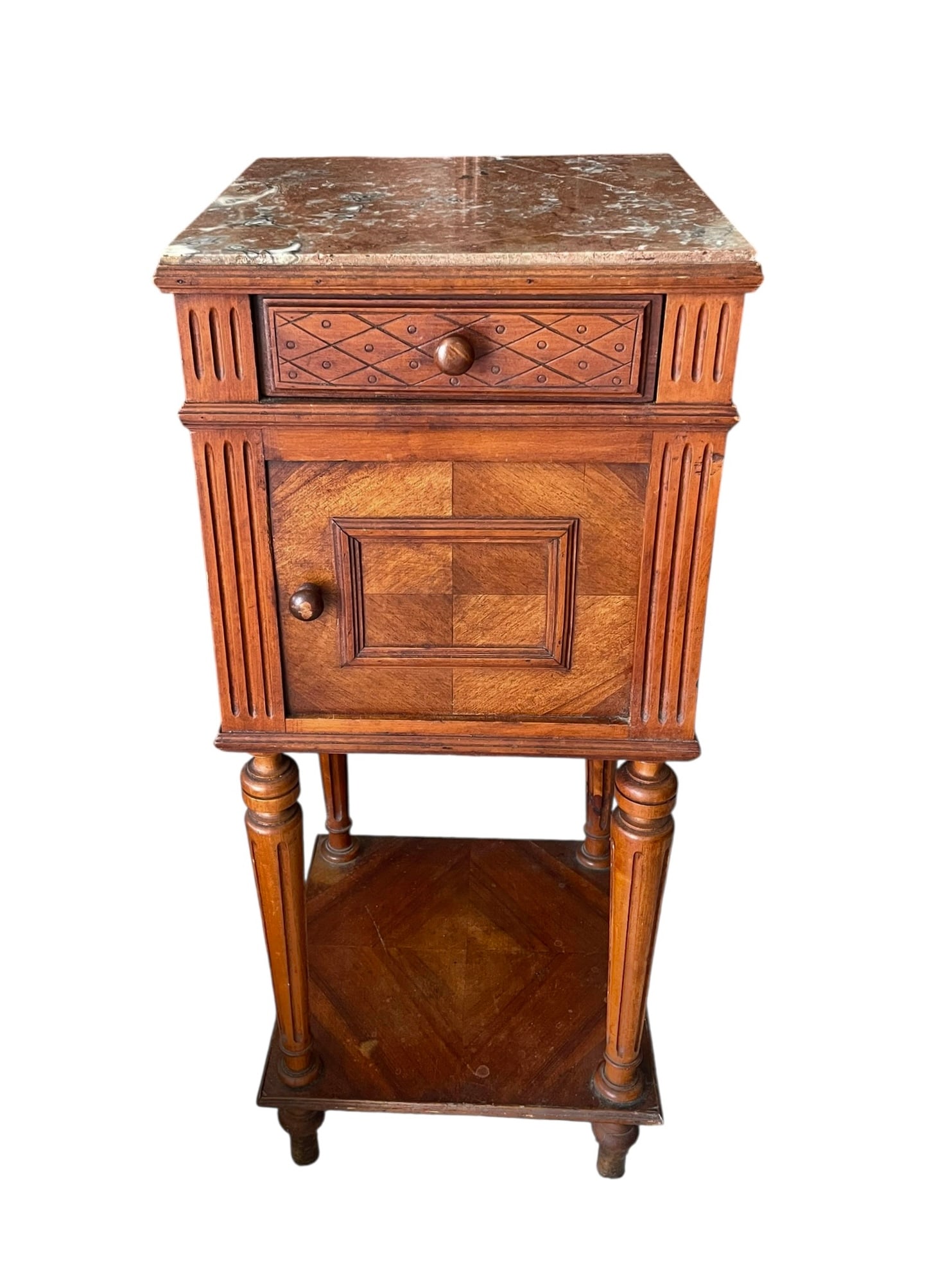 Marble Top Antique Pot Cupboard: Marble top bedside table or nightstand with a door for storing a chamber pot. Pink marble top with typical slight scratches. The interior has broken pieces of stone, as seen in