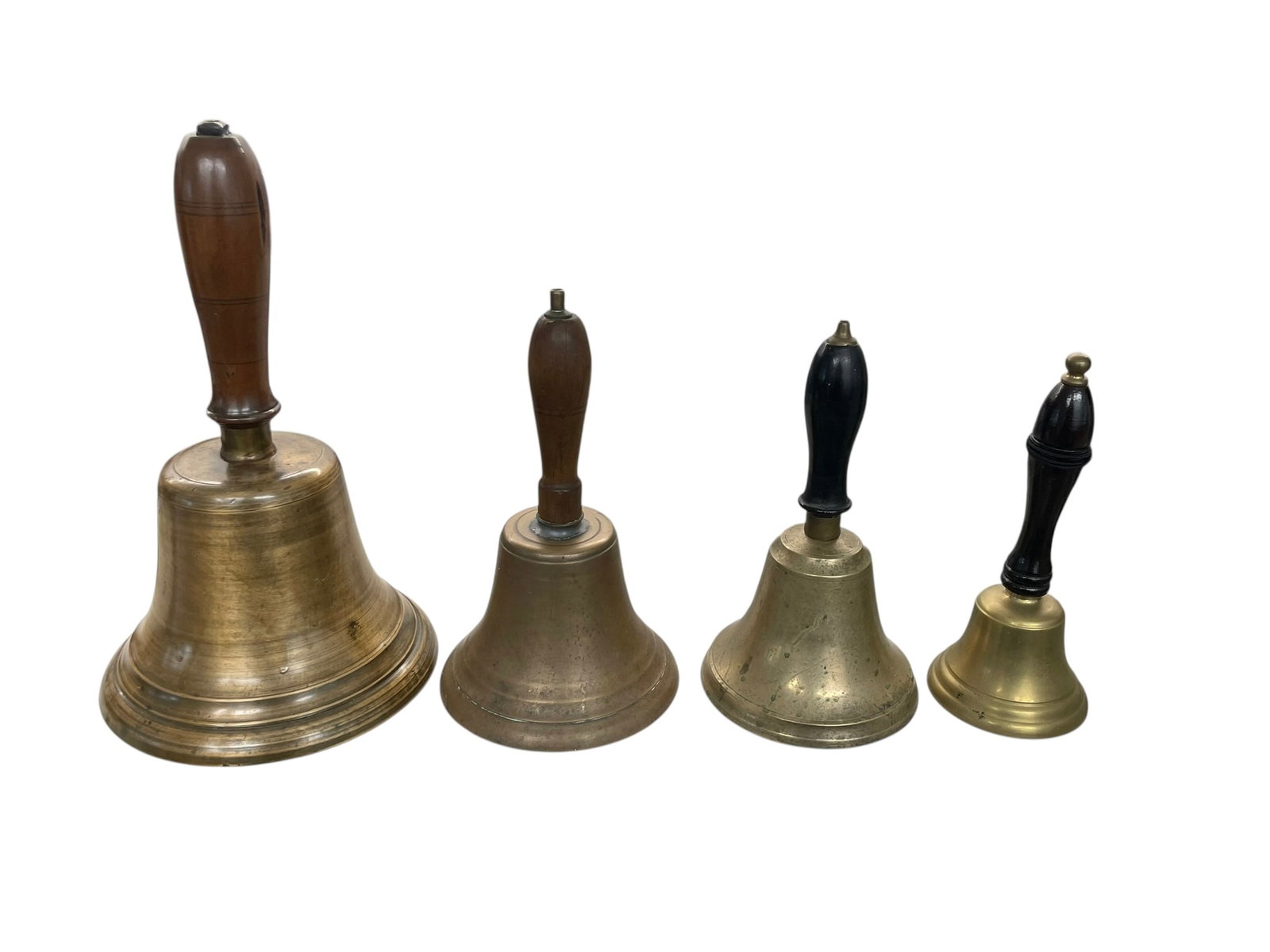 4 Brass School Bells Including Large 12' Size: 4 brass school bells with wood handles. One is a smaller desk bell (8" tall), two are 8"-9" tall, and the largest is a nice 12" antique school bell.