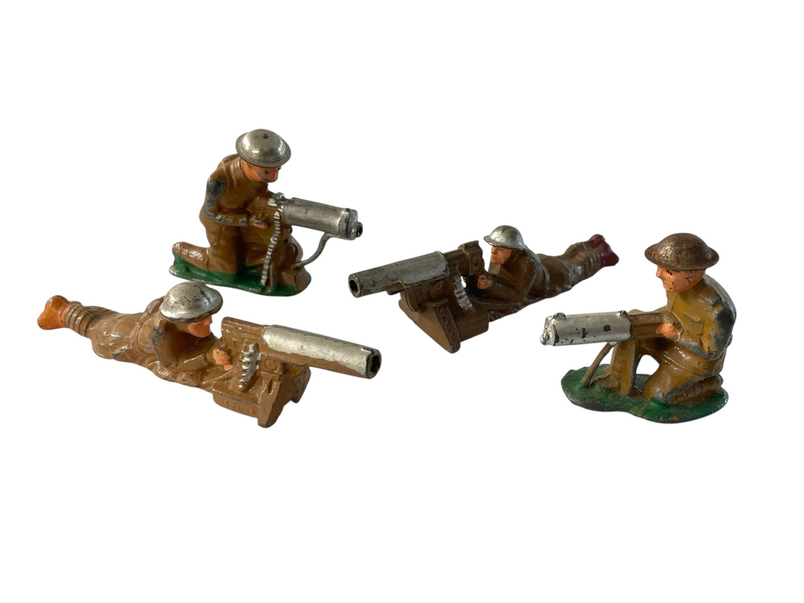4 Barclay Manoil Lead Toy Soldiers: WWI soldiers including two laying machine gunners (one is marked M12 USA), and two kneeling gunners (one is marked Made in USA). 1 1/4" to 2 1/4" tall.