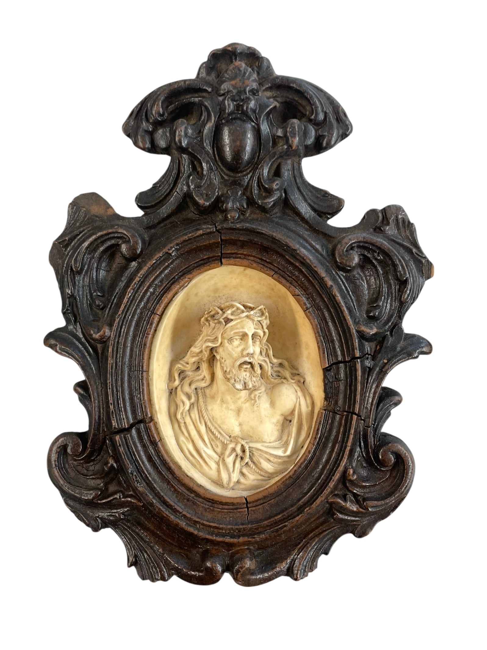 19th Century Carved Wall Plaque of Jesus Christ: European plaque, probably French, with carved wood frame. The high-relief detailed figure is Jesus wearing a crown of thorns, likely carved from meerschaum. 8.5" long.