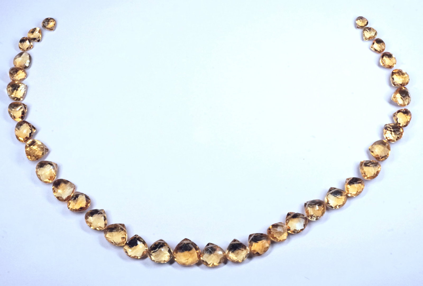 A lot of 35 double faceted Citrine briolette drops.: A lot of 35 double faceted Citrine briolette drops for jewelry making. Various sizes: Smallest: 6x6mm. Largest: 12x12mm. Total weight: 23 grams/approx: 115ct. High quality from India.
