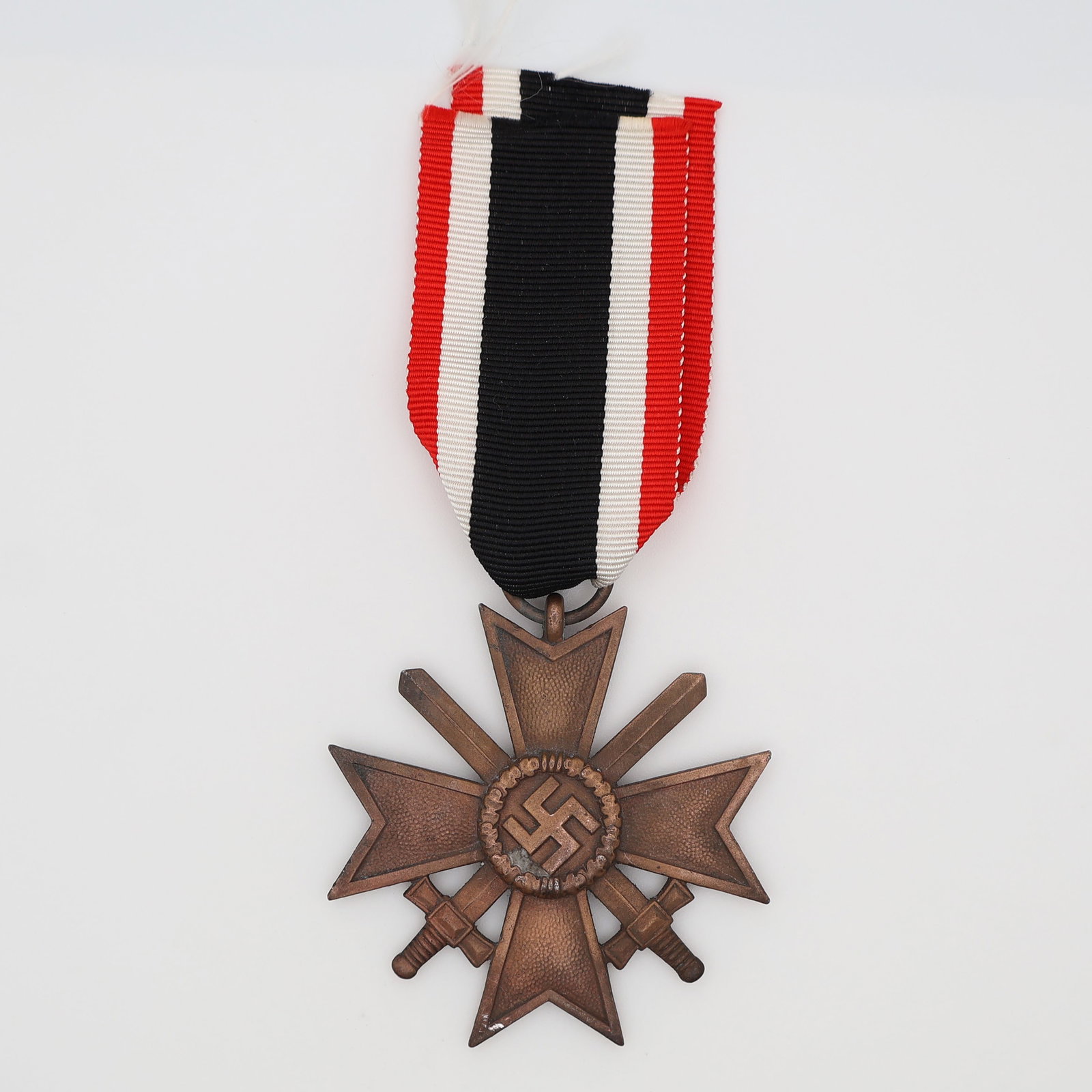 German WWII War Merit Cross II Class w/ Swords, Maker "10": German, Third Reich (c. 1939-1945). War Merit Cross (Kriegsverdienstkreuz) II Class with swords, in bronzed zinc, a Maltese cross with crossed swords between the arms and a central wreathed mobile swa