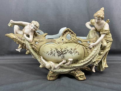Unique figural jardiniere with an Art Nouveau nautical motif. The baby at the bottom seems to be: Unique figural jardiniere with an Art Nouveau nautical motif. The baby at the bottom seems to be caught in a fishing net and there are fish details on the base. Hand painted with gold accents. Stamped