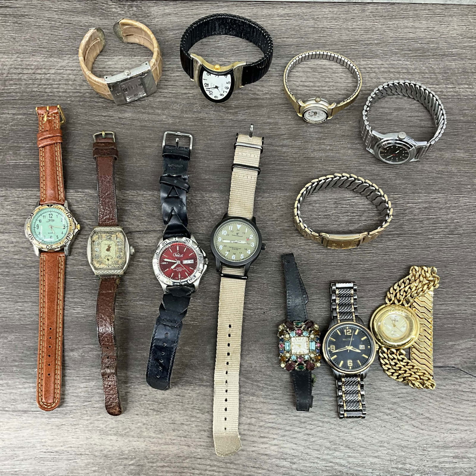 Lot Watches- Bulova, Waltham, more: 12 watches, conditions vary. makers include Smith & Wesson, Waltham, Bulova and more. One with inscription To Joe from Sue 12-25-11. Size: various
