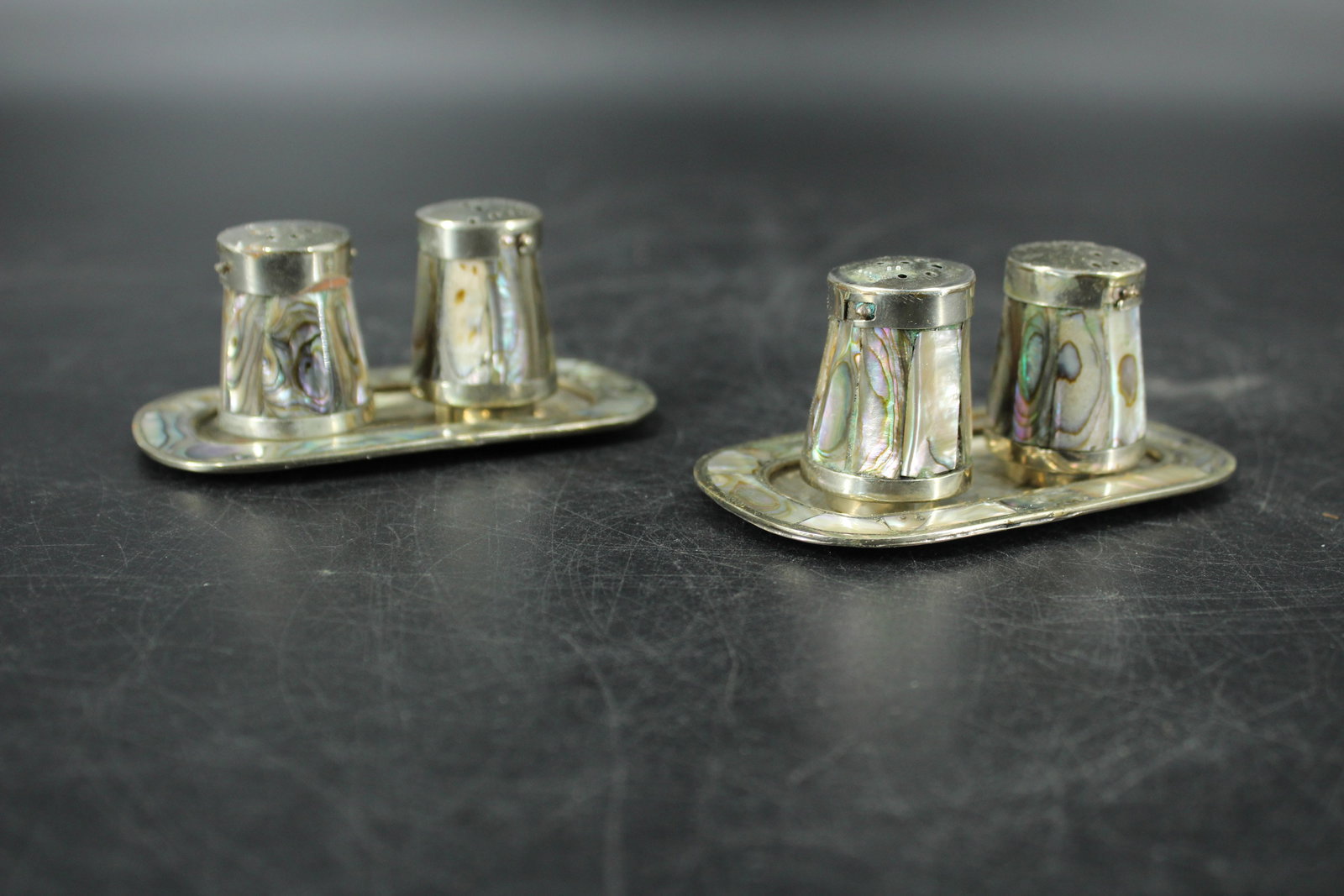 Pair Mexican Inlaid Abalone Salt and Pepper Sets: Pair Mexican Inlaid Abalone Salt and Pepper Sets. Size: 1.5" x 3.5" x 2" each set.