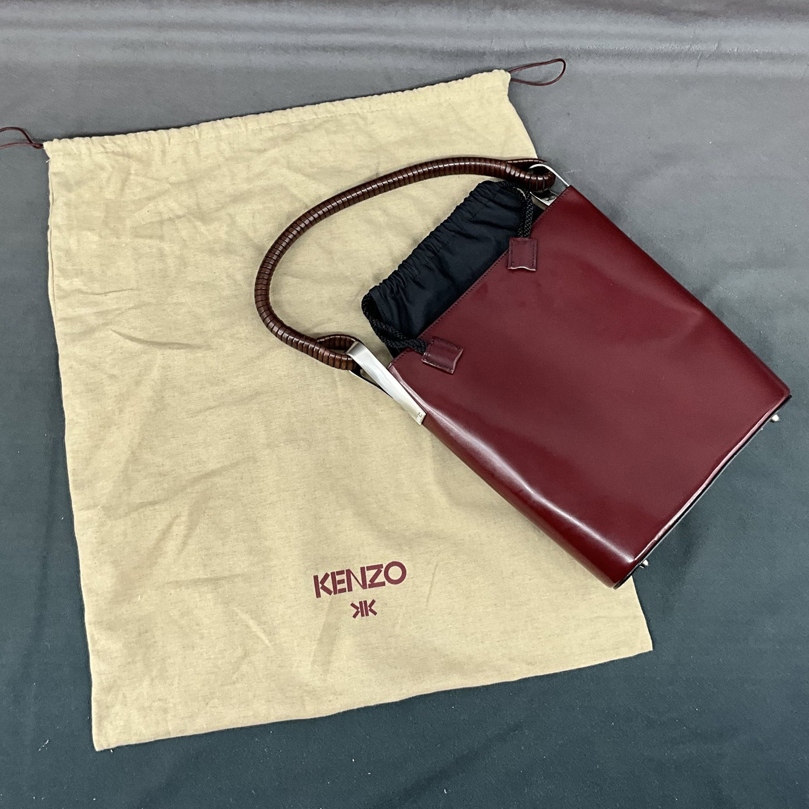 Vintage Kenzo Leather Top Handle Handbag: Vintage leather and fabric bag from Kenzo, France. Stiff box leather with draw string fabric closure, interesting handle details including custom hardware, one interior pocket, comes with dust bag. Si